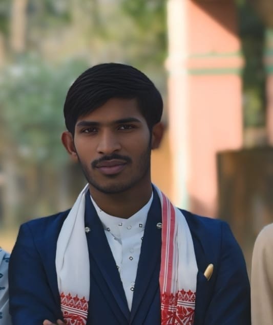 Portrait of Priya Sharma, President of Sonkuchi Young Bright Society - A middle-aged woman in a blue sari with glasses